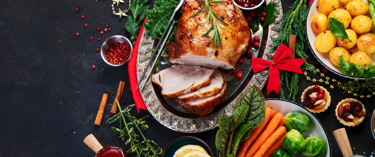 Traditional Christmas dinner on dark background.